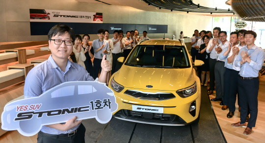 기아차는 지난 19일 오후 회사의 브랜드 체험관인 '비트 360'에서 소형 SUV(스포츠유틸리티차) 스토닉의 1호차 전달 행사를 개최했다고 21일 밝혔다. 사진은 스토닉 1호차 주인공인 장두석씨가 기념촬영을 하고 있는 모습.<기아자동차 제공>